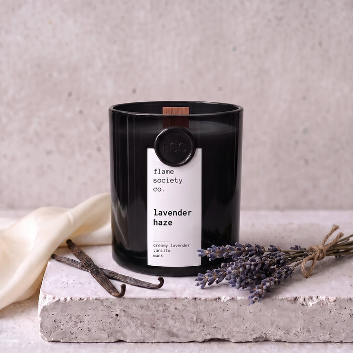 Lavender Haze candle styled with lavender, vanilla and silk on concrete — Flame Society Co.