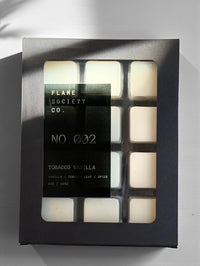 Box of Flame Society Co. candles with six visible candles inside.
