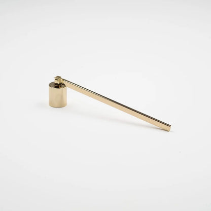 Gold wick snuffer on white background