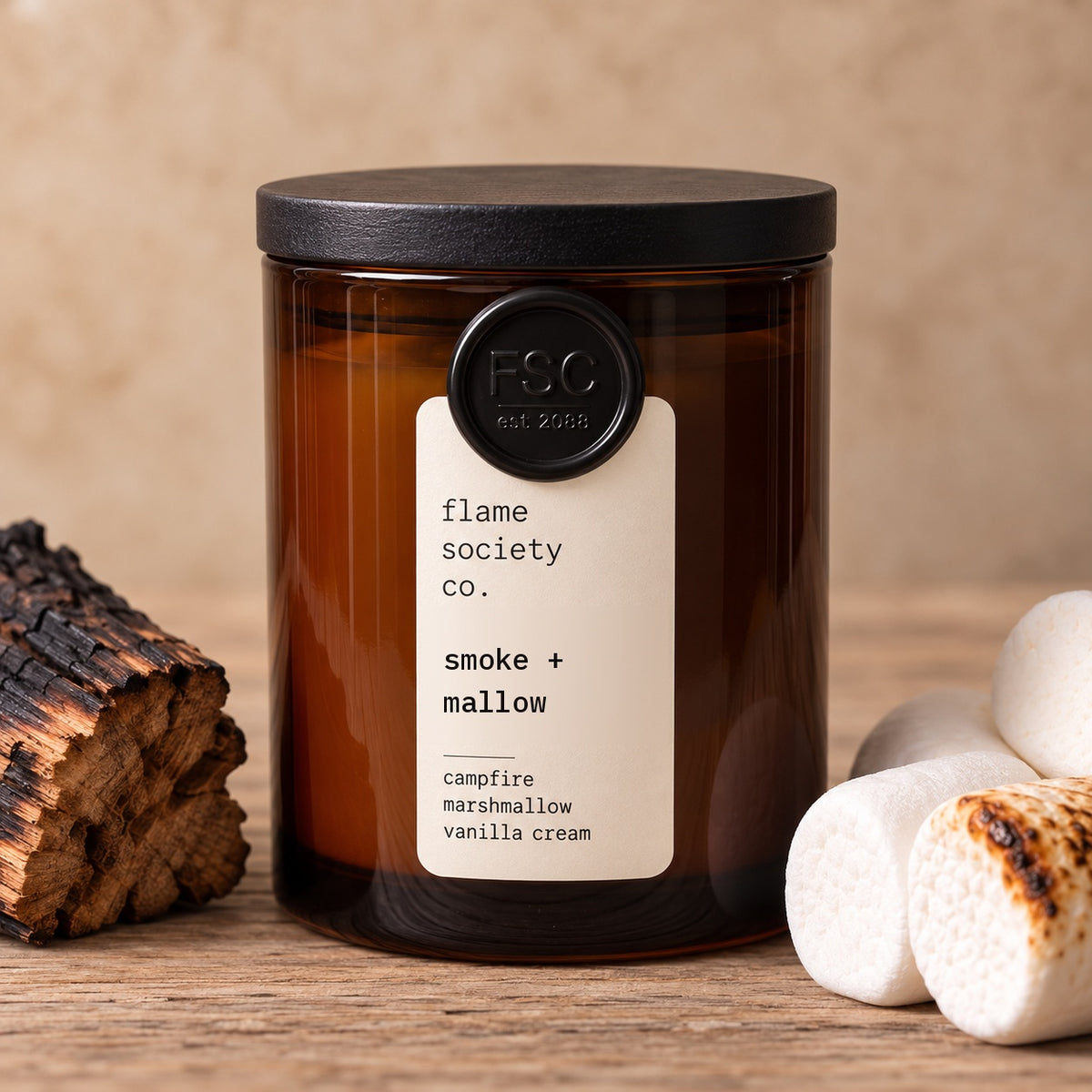 Smoke + Mallow 10oz amber jar candle with black wood lid, charred firewood and toasted marshmallows - Flame Society Co.