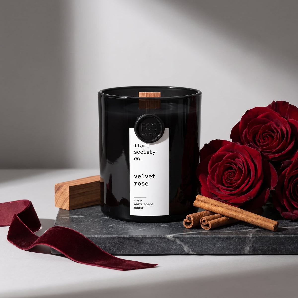 Flame Society Co. Velvet Rose candle in black glass vessel with red roses, cinnamon and cedar.