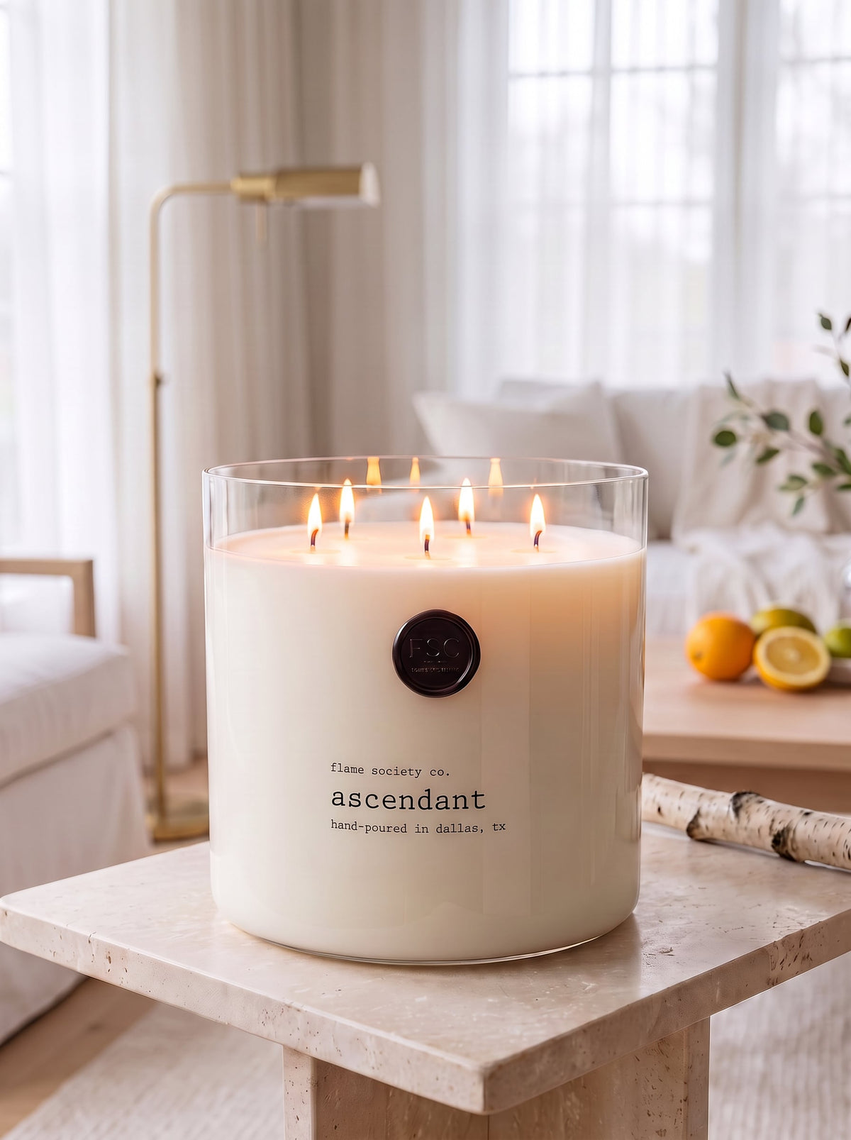 Ascendant XL 150oz statement candle in a clear glass vessel in a bright modern sunroom — Flame Society Co.