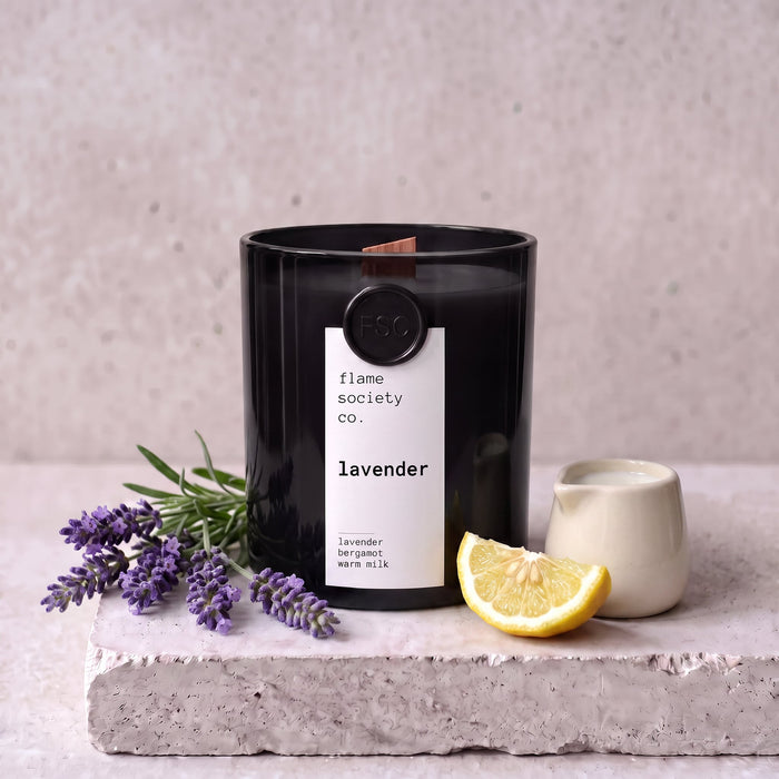 Lavender candle styled with fresh lavender, bergamot and warm milk on concrete — Flame Society Co.