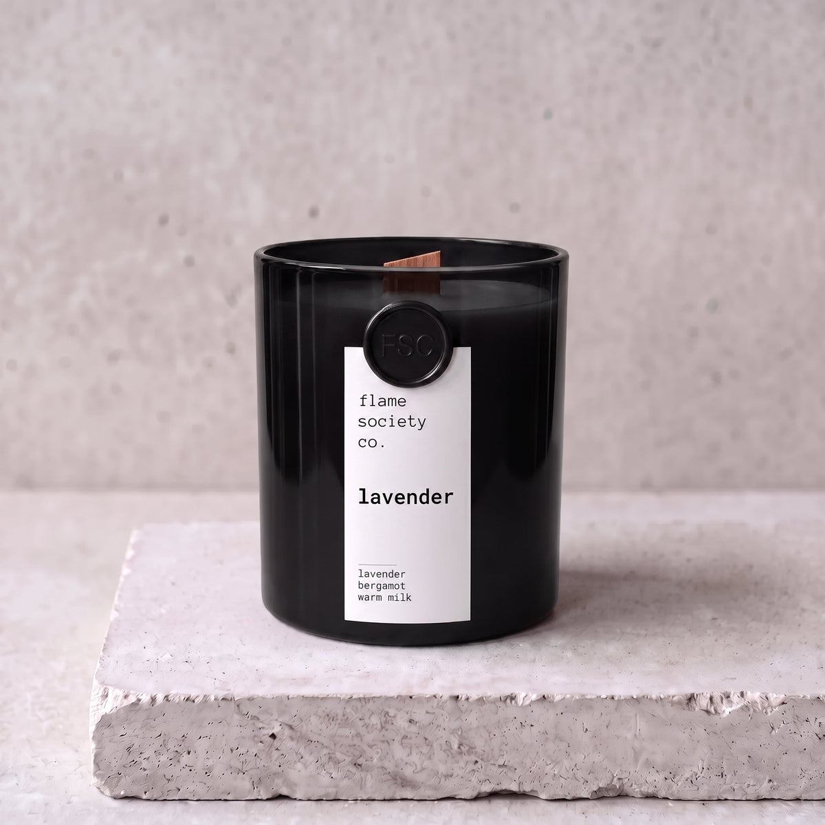 Lavender candle hero — black glass vessel with wooden wick, lavender, bergamot and warm milk — Flame Society Co.