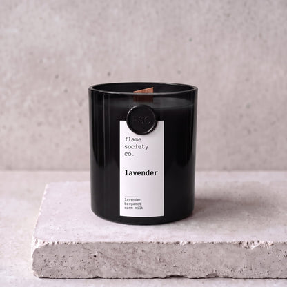 Lavender candle hero — black glass vessel with wooden wick, lavender, bergamot and warm milk — Flame Society Co.