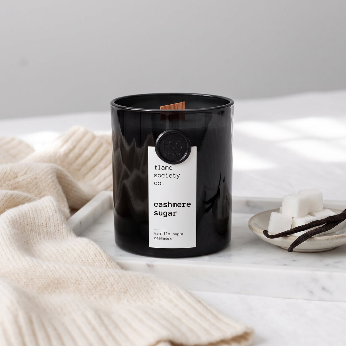 Flame Society Co. Cashmere Sugar candle in black glass vessel with vanilla sugar and cashmere styling.