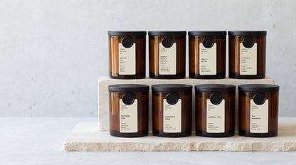 The limited-edition 10oz amber jar collection on travertine steps — flame society co.
