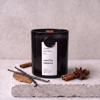 Vanilla Tobacco candle styled with vanilla, tobacco leaf and warm spice on concrete — Flame Society Co.