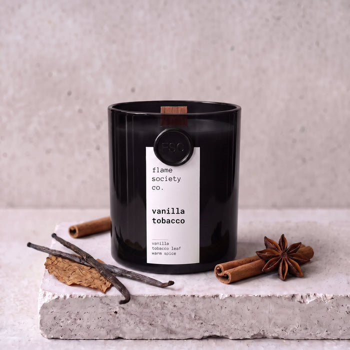 Vanilla Tobacco candle styled with vanilla, tobacco leaf and warm spice on concrete — Flame Society Co.