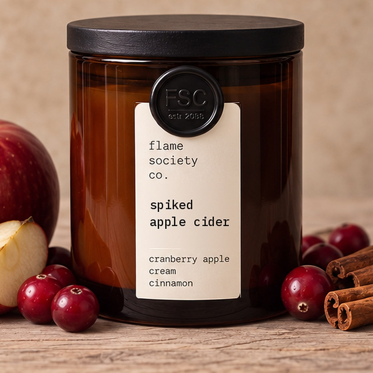 Spiked Apple Cider 10oz amber jar candle with black wood lid, apples, cranberries and cinnamon - Flame Society Co.