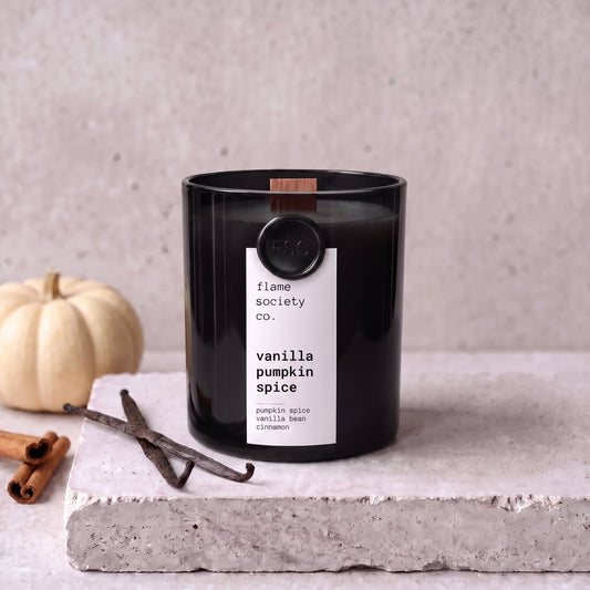 Vanilla Pumpkin Spice candle styled with pumpkin, vanilla and cinnamon on concrete — Flame Society Co.