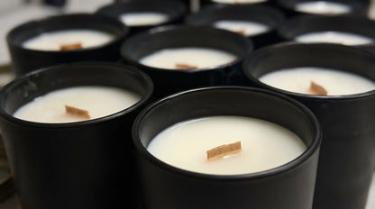 Bulk wholesale candles styled on a retail display shelf — Flame Society Co. trade program