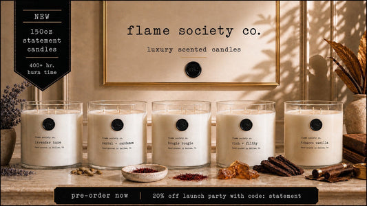 Flame Society Co. collection of five oversized luxury scented candles in clear glass vessels on a marble surface.