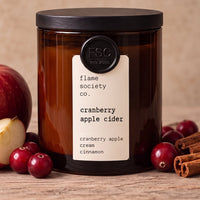 Cranberry Apple Cider 10oz amber jar candle with black wood lid, apples, cranberries and cinnamon - Flame Society Co.