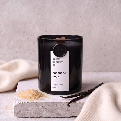 Cashmere Sugar candle styled with sugar, vanilla and cashmere on concrete — Flame Society Co.
