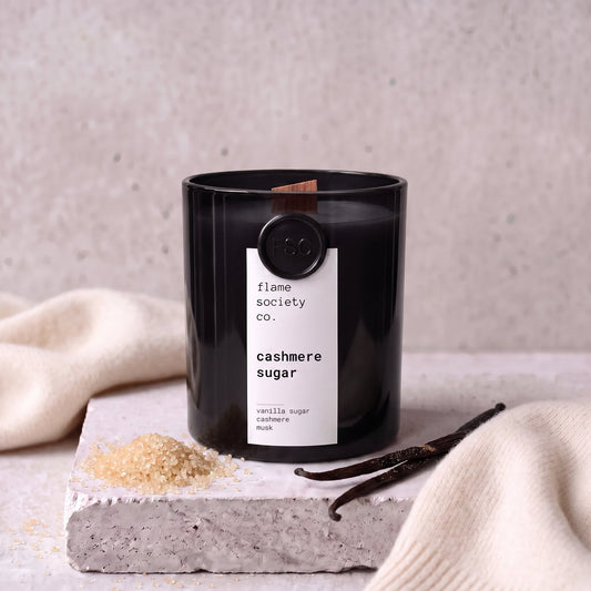 Cashmere Sugar candle styled with sugar, vanilla and cashmere on concrete — Flame Society Co.
