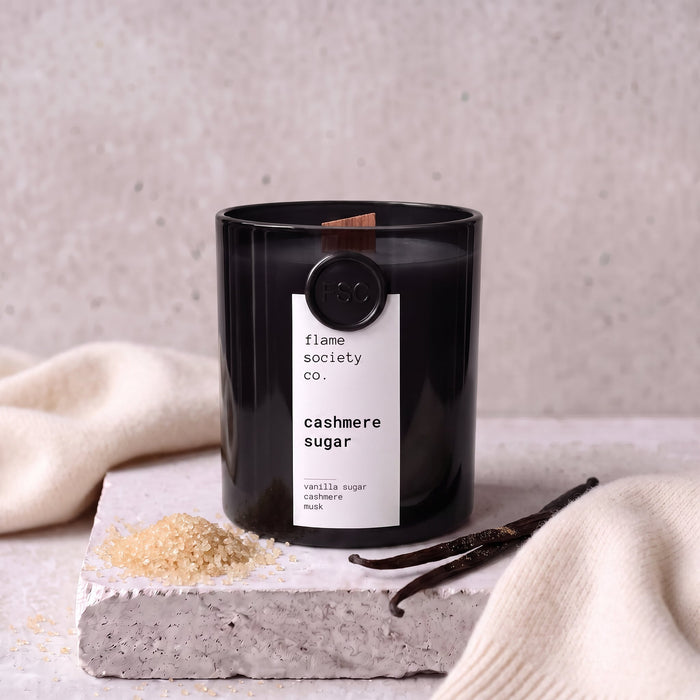 Cashmere Sugar candle styled with sugar, vanilla and cashmere on concrete — Flame Society Co.
