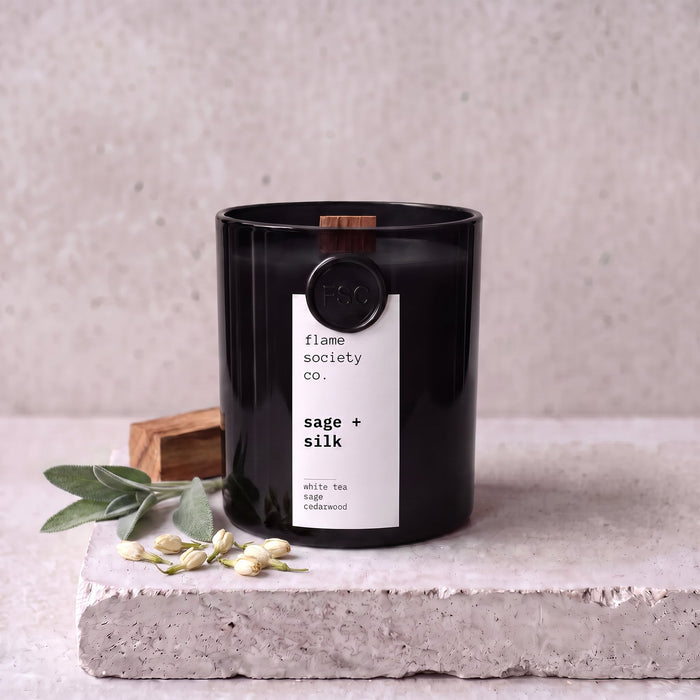 Sage + Silk candle styled with sage, white tea and cedarwood on concrete — Flame Society Co.
