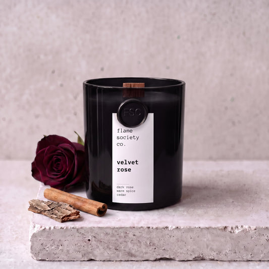 Velvet Rose candle styled with dark rose, cinnamon and cedar on concrete — Flame Society Co.