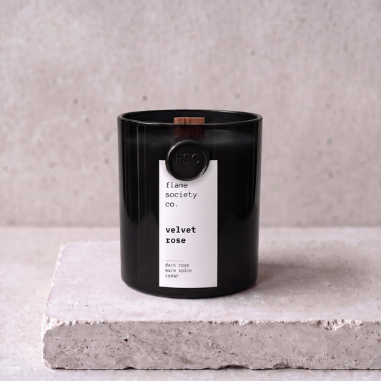 Velvet Rose candle hero — black glass vessel with wooden wick, dark rose, warm spice and cedar — Flame Society Co.