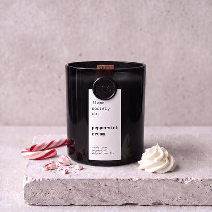 Peppermint Cream candle styled with candy cane, peppermint and whipped cream on concrete — Flame Society Co.