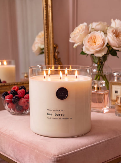 Her Berry XL 150oz statement candle in a clear glass vessel in a blush dressing room — Flame Society Co.